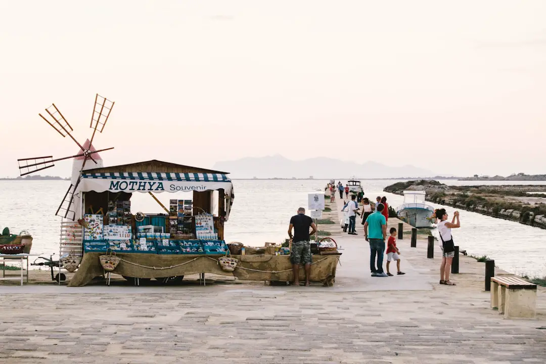 people standing near dock and store during daytime