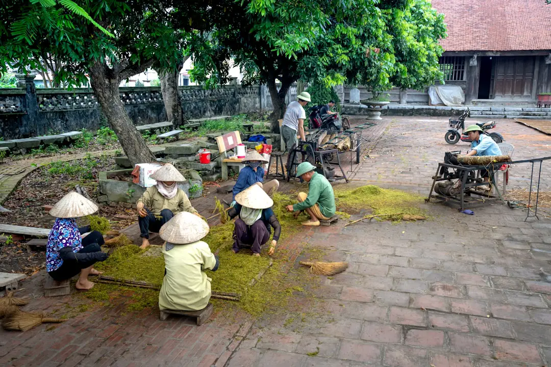 a group of people sitting around a tree