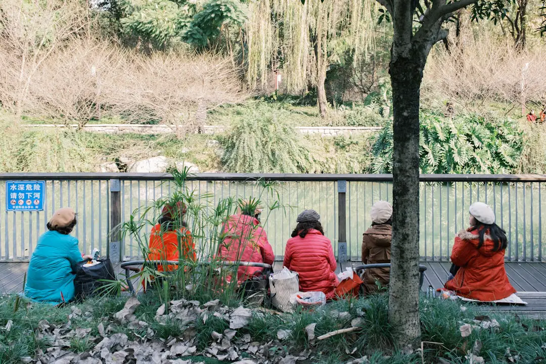 A group of people sitting on top of a park bench